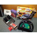 A Nintendo 64 Golden Eye 007edition, a Gamester LMP LX4 wheel and paddles,