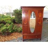 An early 20th century wardrobe with bevel-edged mirror, drawer underneath with inlaid panels 270 (h)