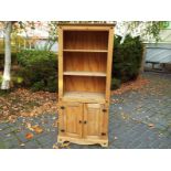 A good modern pine floor-standing display cabinet with cupboard below, 183 cm x 77 cm x 41 cm