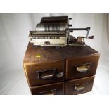 An oak 4 drawer vintage filing box by James Getns of London and a vintage adding machine marked