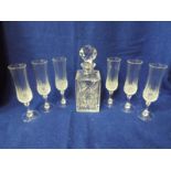 A good quality glass decanter with six glass flutes (qty)