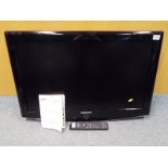 A Samsung LCD television 32 inch screen with remote control and instructions