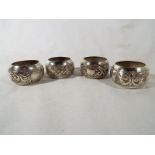 Five white metal Eastern style napkin rings