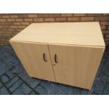 A modern light wood cabinet with twin doors 72cm (h) x 90cm (w) 50cm (d)