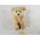A Steiff mohair bear, button in ear with tag labels, blond, 27 cm (h).