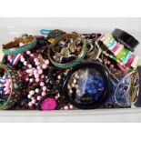 A box of unsorted costume jewellery
