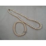 A lady's cultured pearl necklace and bra