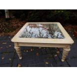 A light wood, square occasional table wi