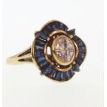 A Diamond and Sapphire Dress Ring. Set in high carat yellow metal. Tests as 18 carat gold. The