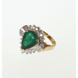 An Emerald and Diamond Ring. Set in high carat yellow metal. stamped 750. tests as 18 carat gold.