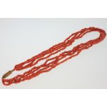 A 19th Century Four Strand Coral Bead Necklace. With gilt metal clasp. Each strand 420mm long. 36.