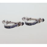 A Pair of High Carat White metal and Sapphire Cufflinks. Tests as 18 carat white gold. Of stylised