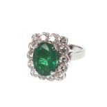 An Emerald and Diamond Ring. Set in high carat white metal. Stamped 750. tests as 18 carat gold. The