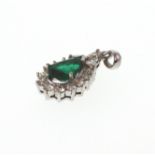 An emerald and Diamond Pendant. Set in high carat white metal stamped 750. tests as 18 carat gold.