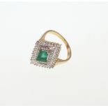 An Emerald and Diamond Ring. Set in high carat yellow metal. Stamped 750. Tests as 18 carat gold.