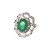 An Emerald and Diamond Ring. Set in high carat white metal. Stamped 585. tests as 14 carat gold. The