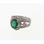 An Emerald and Diamond Ring. Set in high carat white metal. Stamped 585. tests as 14carat gold.