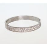 A High Carat White Metal and Diamond set Bangle. Stamped 18K and tests as 18 carat white gold. Set