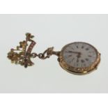 A Gold Enamel Ruby and Seed Pearl Pendant Watch. 19th century. The 25mm white enamel dial with Roman