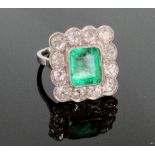 An Emerald and Diamond Ring. The central