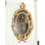 Large oval wall mirror in heavy ornate g