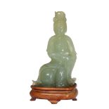 A Chinese carved serpentine figure of Gu