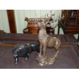 Cast metal stag sculpture and carved ebonised wood lion