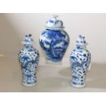 Pair of Chinese blue and white vases and covers and a Chinese blue and white baluster vase and