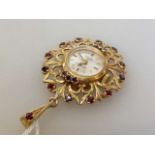 Rotary 9ct gold pendant watch set with red stones,