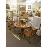 Circular hardwood pedestal dining table and three hardwood elbow chairs