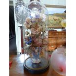 Artificial flower display under glass dome