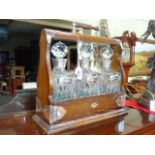 Silver mounted three decanter tantalus with silver spirit labels