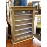 Small glazed door display cabinet with six adjustable shelves