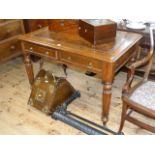 Late Victorian oak two drawer writing table on circular reeded tapering legs