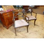 Pair of Regency style mahogany elbow chairs on sabre legs