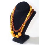 Collection of amber coloured jewellery including necklaces and earrings