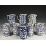 (8) BLUE SPONGEWEAR PITCHERS - 19th c. New England Stoneware Milk Pitchers, with various styles of