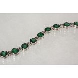 BRACELET - One 14K White Gold, Emerald and Diamond Bracelet with (23) round bezel set emeralds