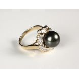 LADY'S RING - 14K Yellow Gold, 11mm Black Pearl and Diamond Ring. Size 8 1/4. Fine condition.