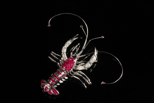 BROOCH - One 18K White Gold, Diamond and Ruby Lobster Form brooch with articulated body. Rubies