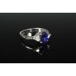 LADY'S RING - One 18K White Gold, Sapphire and Diamond Ring, centered by (1) oval blue sapphire