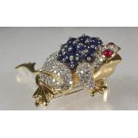 BROOCH - One 18K Yellow Gold, Sapphire, Ruby and Diamond Frog Form Brooch. Blue sapphires weigh
