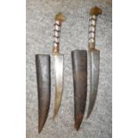 TWO INDIAN DAGGERS, EARLY 20TH CENTURY each with curved fullered blade, brass ferrule extending