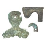 A NORTH-WEST PERSIAN BRONZE AXE-HEAD AND TWO FURTHER BRONZE ELEMENTS, 1000 B.C. in excavated