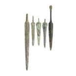 A GROUP OF EXCAVATED BRONZE DAGGERS AND SPEAR BUTTS, PROBABLY NORTH WEST PERSIAN, FIRST MILLENIUM
