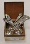 A silver cigarette box, together with fifteen small spoons. (16) CONDITION REPORT: Fair condition,