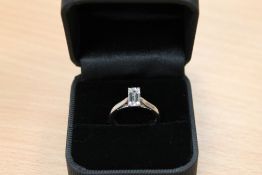 A platinum emerald cut diamond ring.