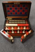 An early twentieth century burr yew wood games compendium, with compartmentalised interior, width 33