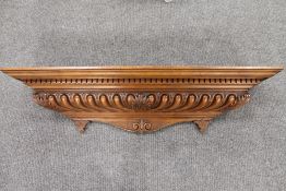 A carved mahogany cornice, width 110 cm.