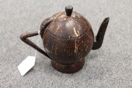 A carved cocunut in the form of a teapot, height 16.5 cm. CONDITION REPORT: An unusual item in